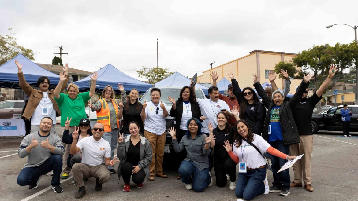 Community members celebrate at the Take Charge event, promoting electric vehicle awareness in East Los Angeles.