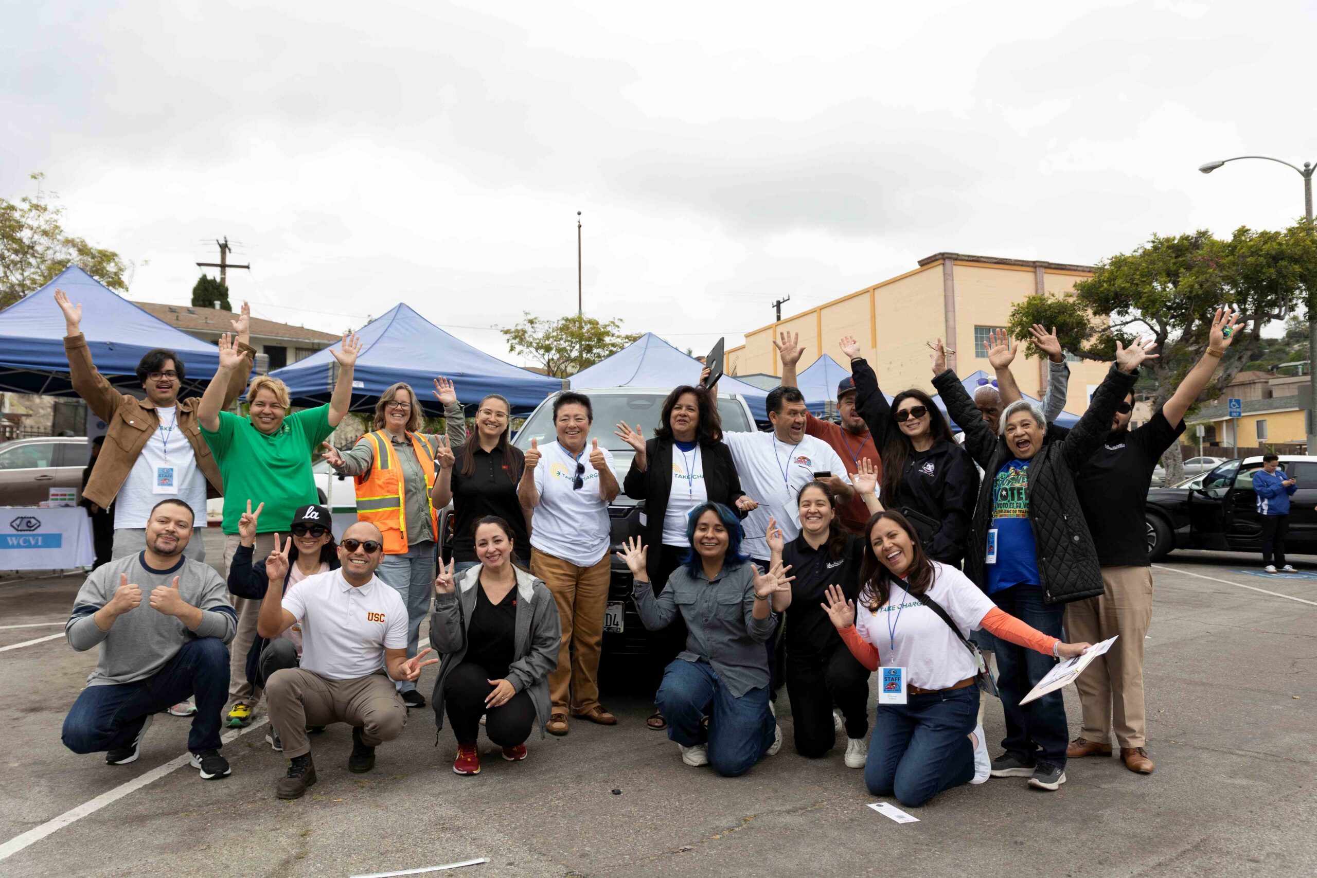 Community members celebrate at the Take Charge event, promoting electric vehicle awareness in East Los Angeles.