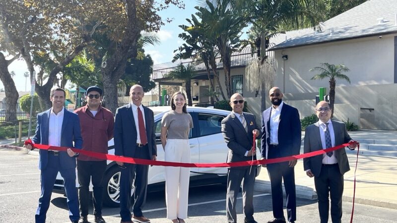 Local leaders cut a ribbon to inaugurate a new electric vehicle charging station, promoting sustainable transportation initiatives.